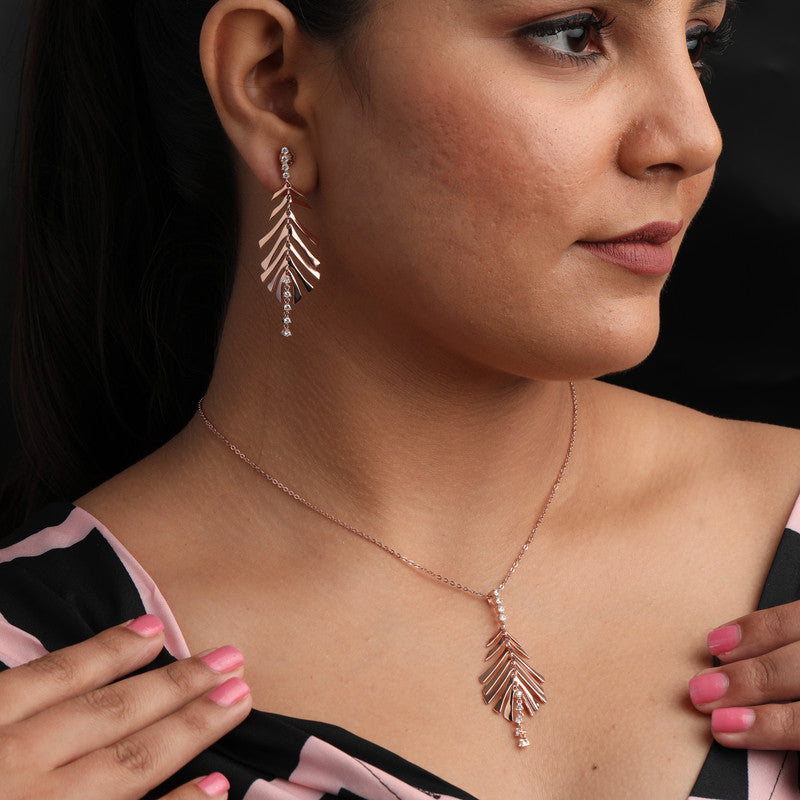 Woman wearing a feather design rose gold silver set, adding elegance to her festive celebration look.