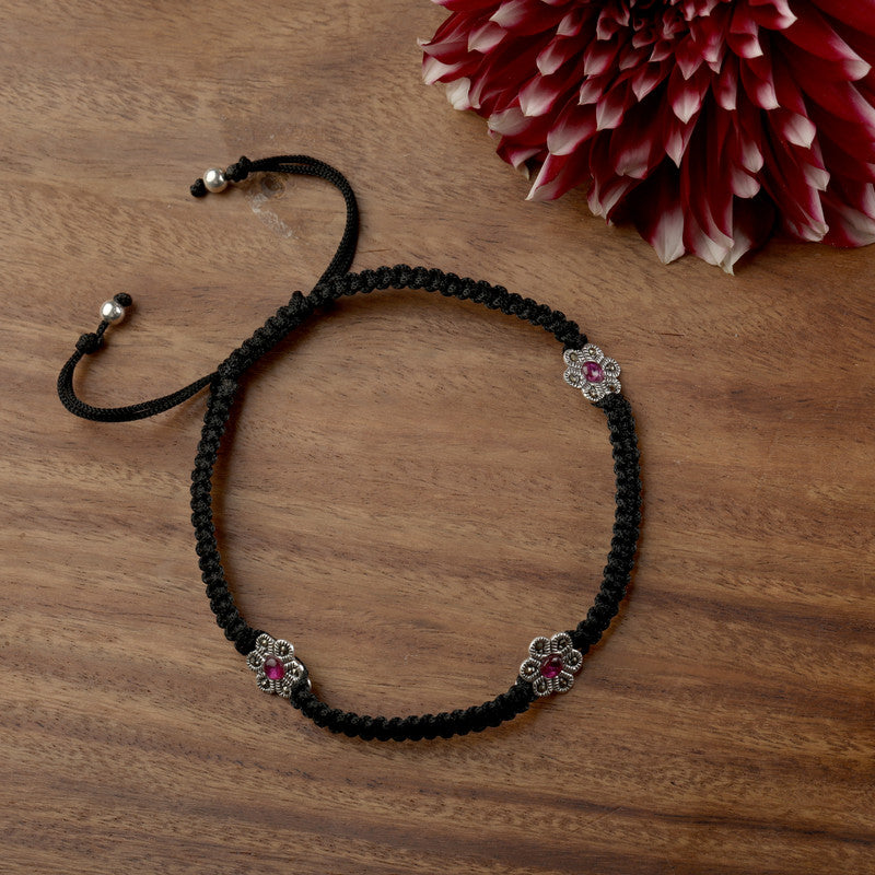 Shimmering 925 silver thread anklet with floral charm, glowing accessory for Karwa Chauth and Diwali wear.