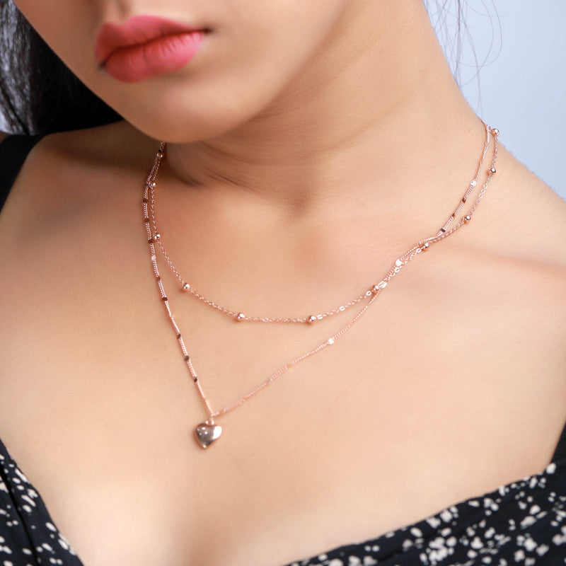 Woman wearing a layered heart silver necklace, adding love and sparkle to her festive look.