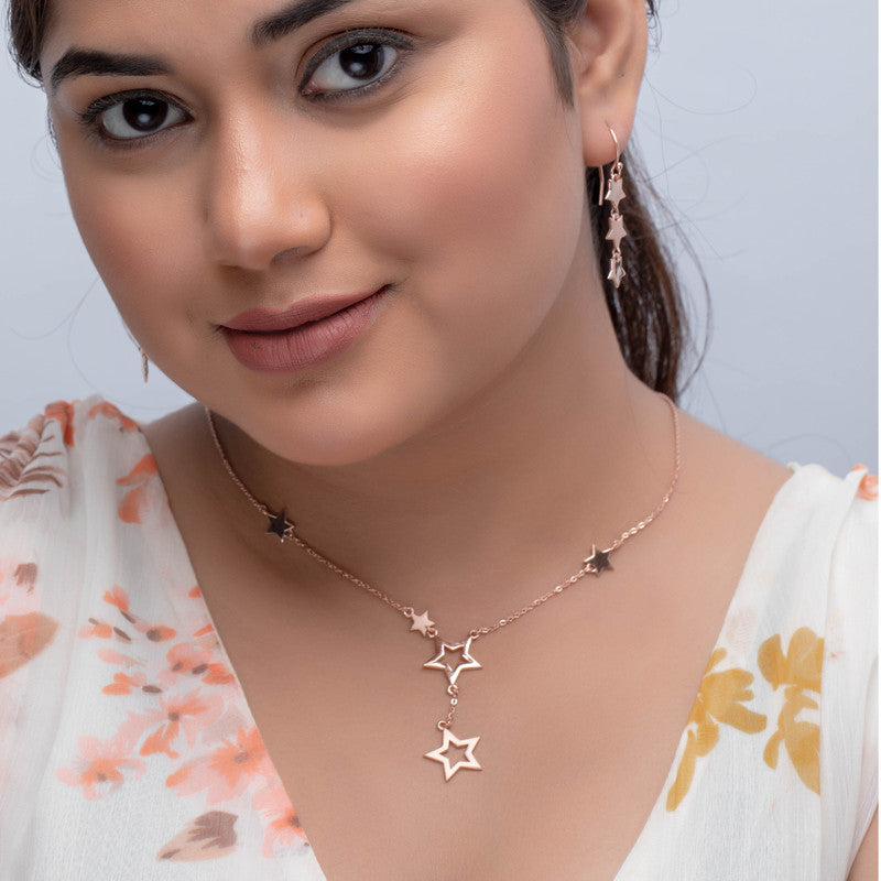 Woman wearing a star rose gold silver necklace, adding charm to her festive celebration look.