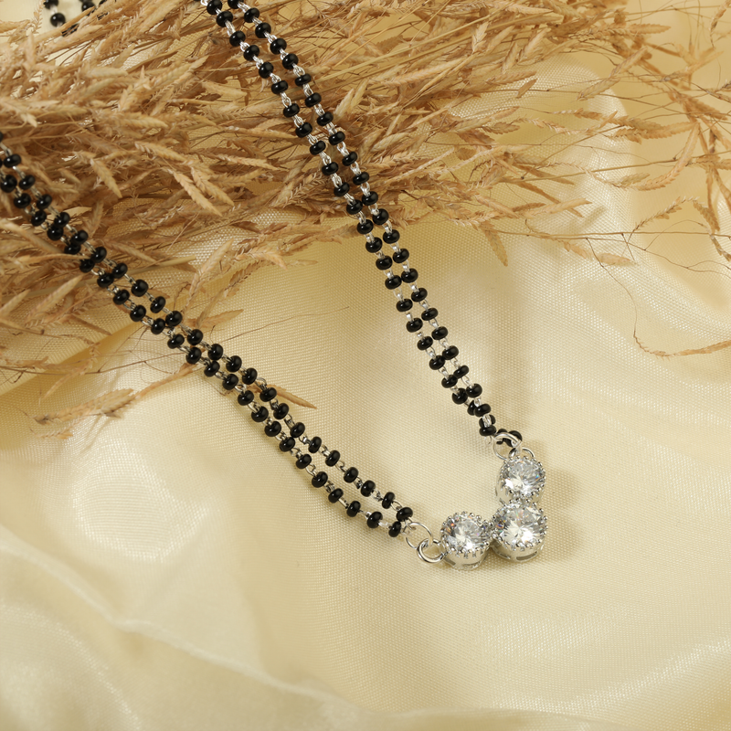 925 Silver Auspicious Embrace Mangalsutra displayed on festive background – traditional silver jewellery with graceful design.