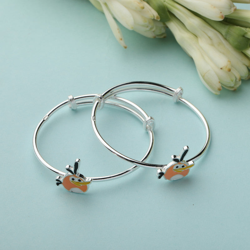 Kids Silver Angry Birds Kada with Cartoon Bird Charm styled on fabric background