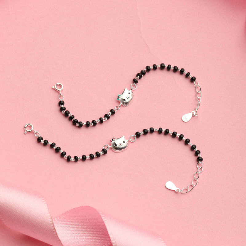 Kids Silver Kitty Nazariya Bracelet with Cute Kitty Charm styled on fabric background