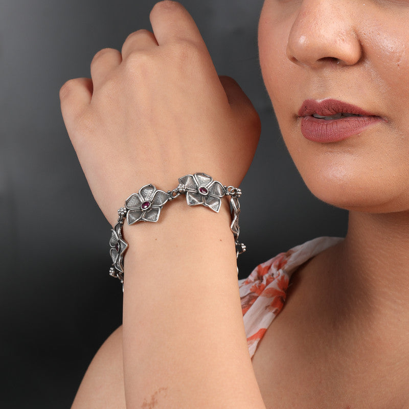 Woman wearing minimalist oxidized silver bracelet on wrist.