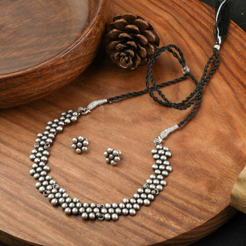 Oxidized Silver Ball Flower Necklace displayed on festive prop – Raksha Bandhan and Bhai Dooj gift idea