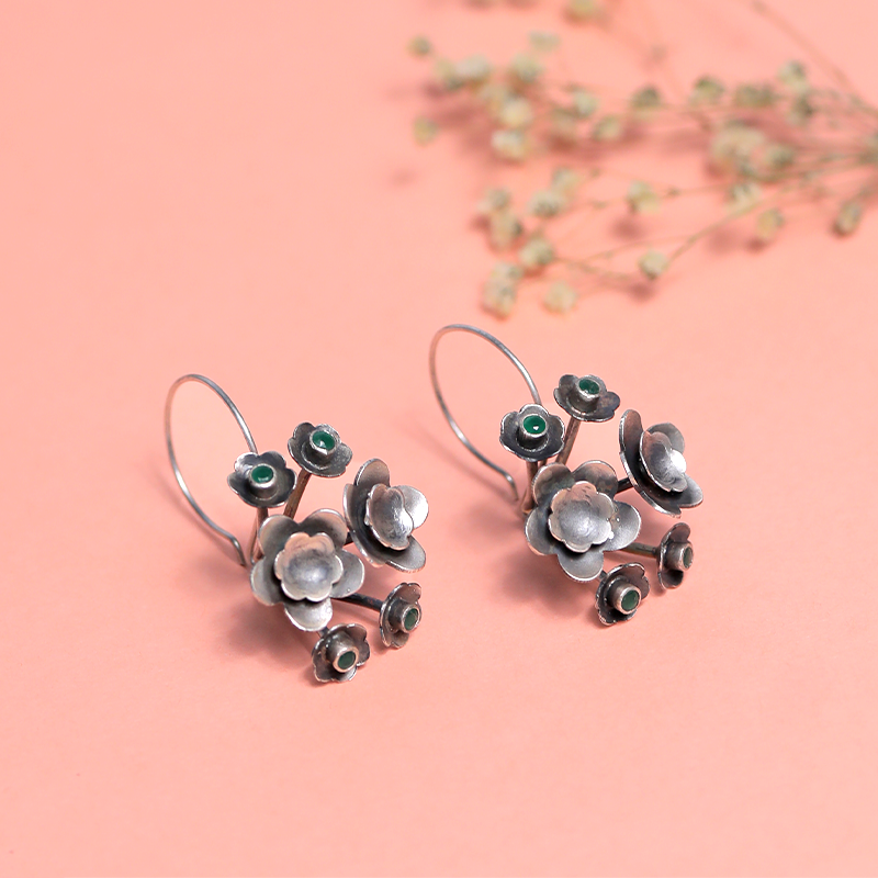 Designer Oxidized Silver Flower Hook Earrings with Ethnic Backdrop – Trendy Silver Jewellery for Festivals and Celebrations
