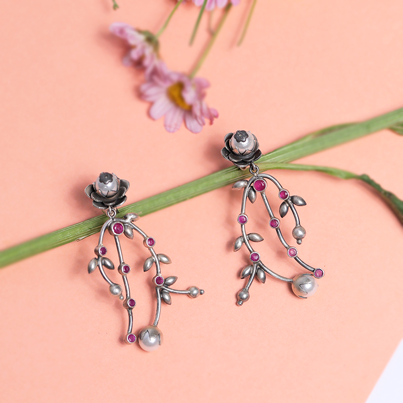 Designer Oxidized Silver Flower & Leaf Earrings with Ethnic Backdrop – Trendy Silver Jewellery for Festivals, Weddings and Celebrations
