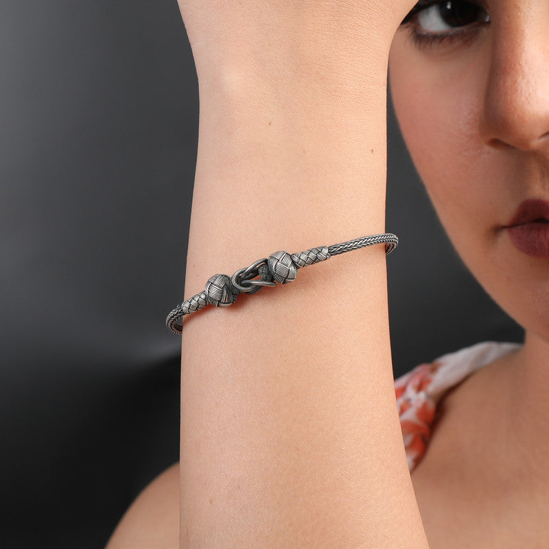 Woman wearing Oxidized Silver Reef Knot Bracelet – stylish oxidized jewelry for festivals like Diwali, Navratri, Eid and wedding celebrations