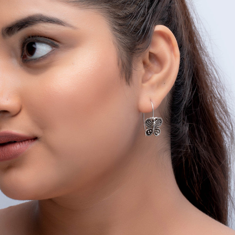 Oxidized silver butterfly earrings on model – lightweight statement accessory for weddings, Karwa Chauth, and cultural events
