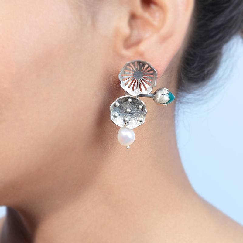 Oxidized silver flower bud studs on model – elegant small earrings for weddings, parties, and traditional outfits