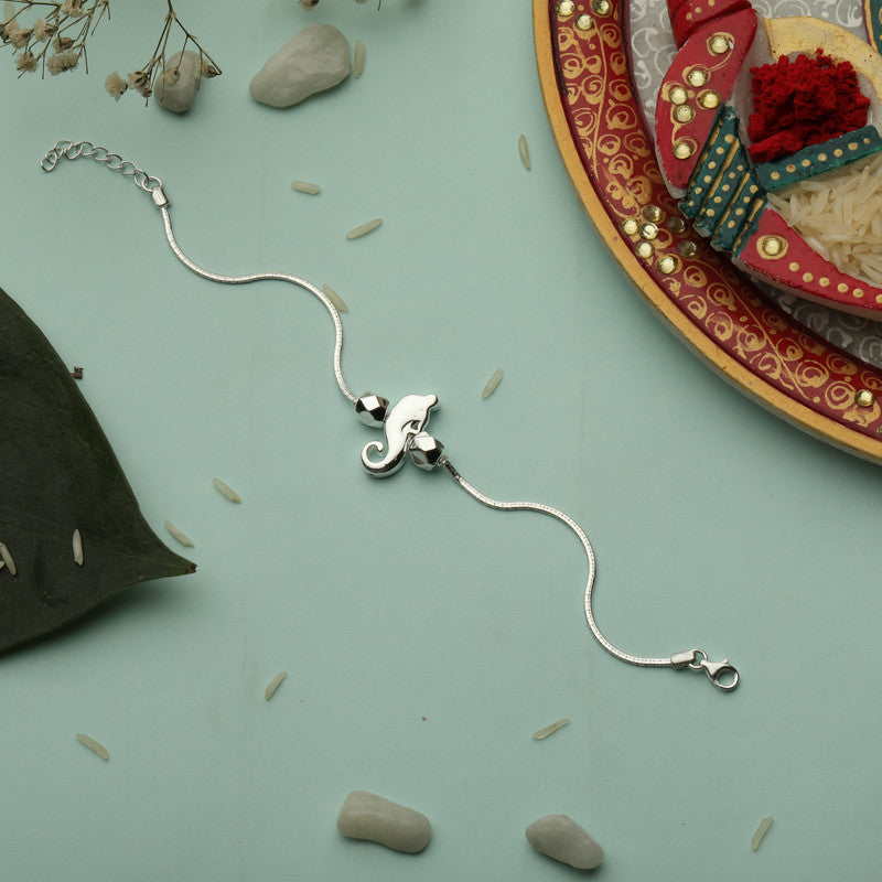 Silver rakhi for kids featuring Lord Ganesha – original silver rakhi design for Raksha Bandhan celebration
