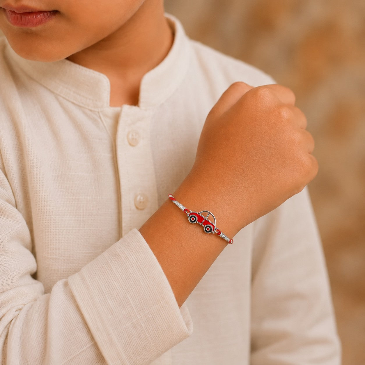 Kid wearing Silver Car Design Rakhi made with 925 Sterling Silver