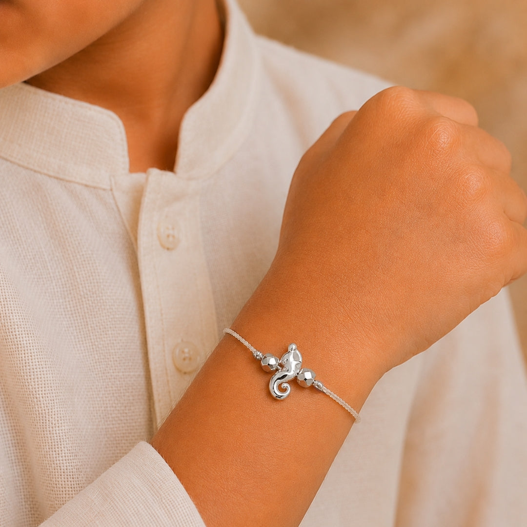 kid wearing a premium 925 sterling silver Ganesha rakhi, crafted especially for children to celebrate Raksha Bandhan with blessings, purity, and style.