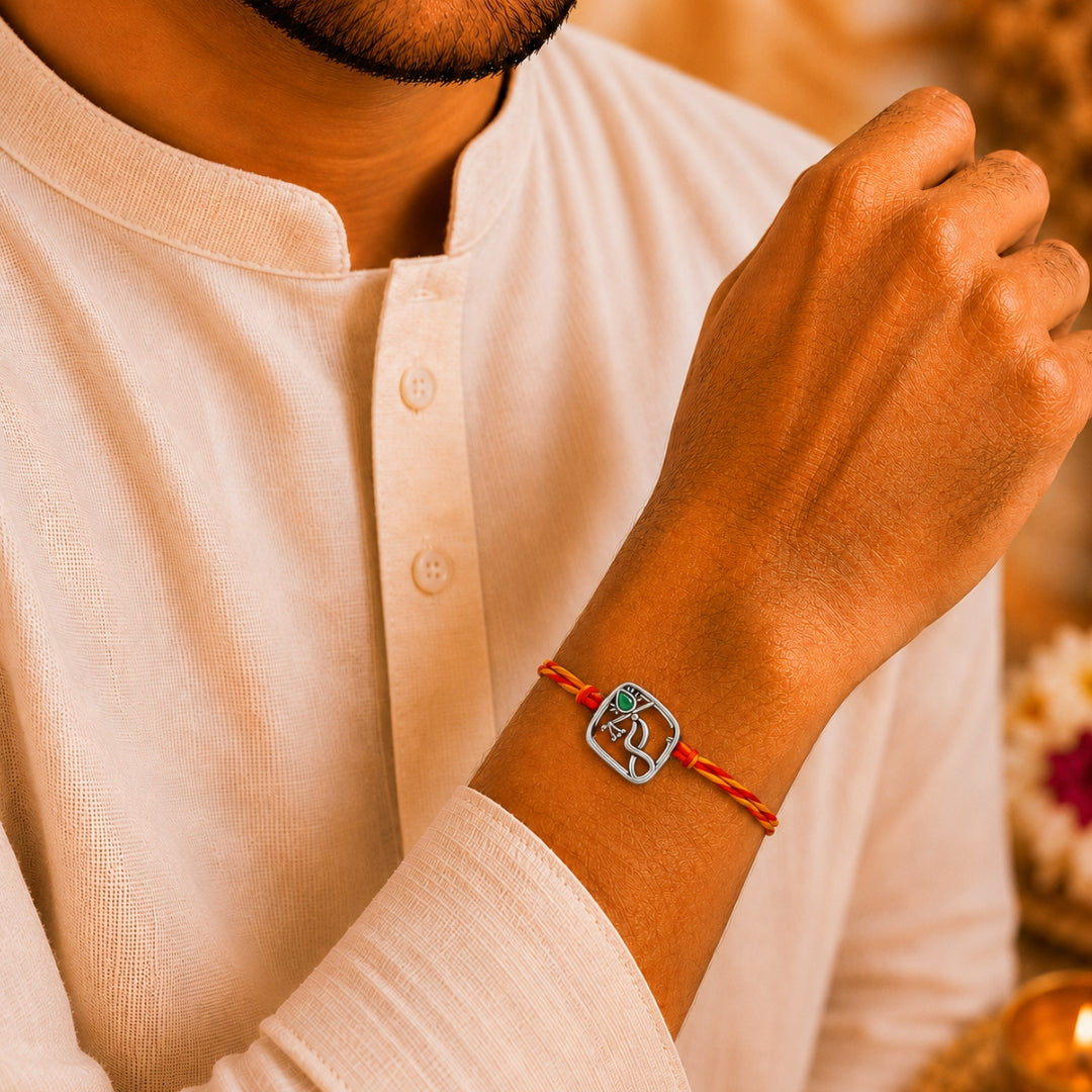 Brother wearing Silver Krishna Bansuri Rakhi by Silviya – 925 silver spiritual rakhi for Raksha Bandhan.