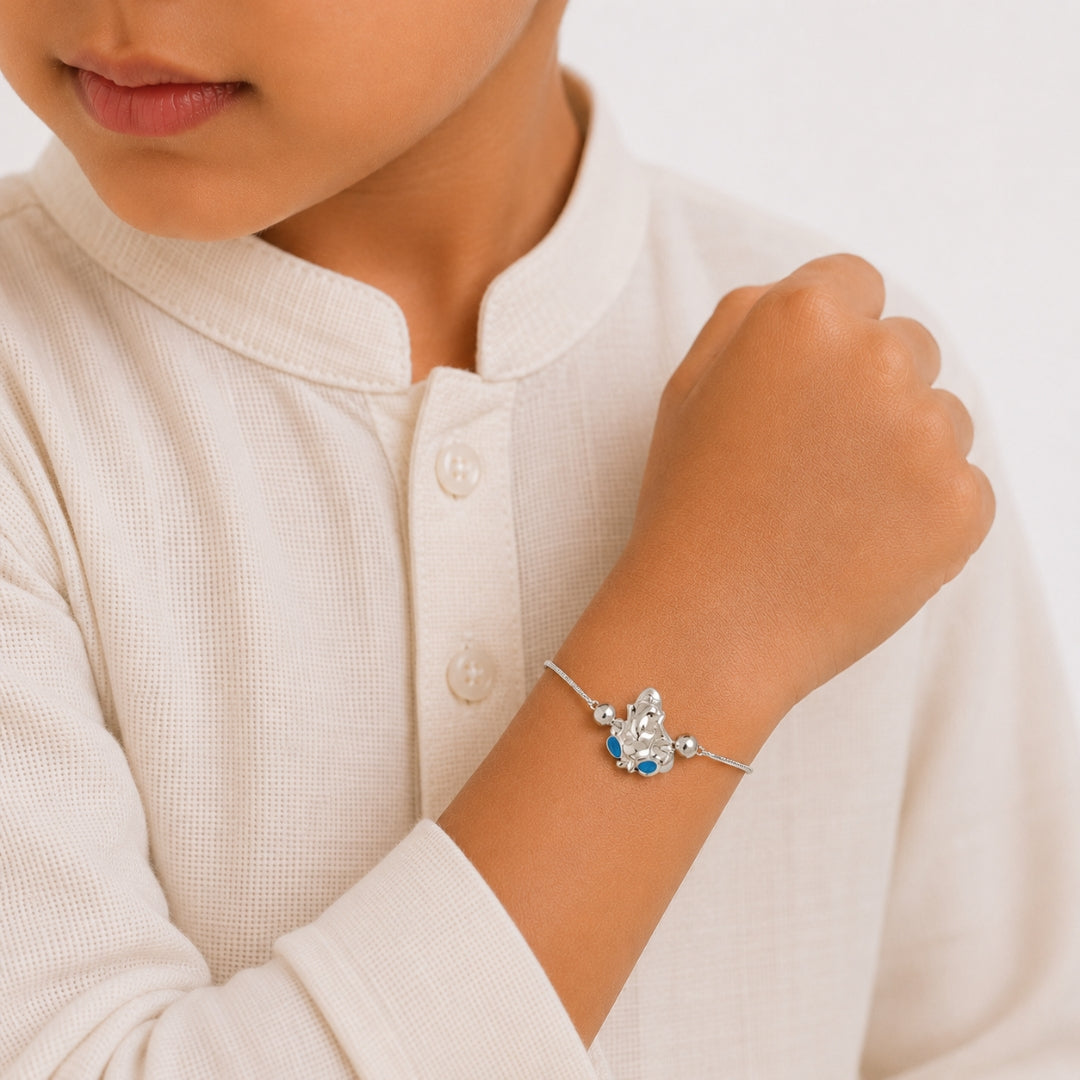 Silver Lord Ganesha Rakhi for Kids placed with roli chawal and festive decor – premium 925 silver kids Raksha Bandhan gift by Silviya.