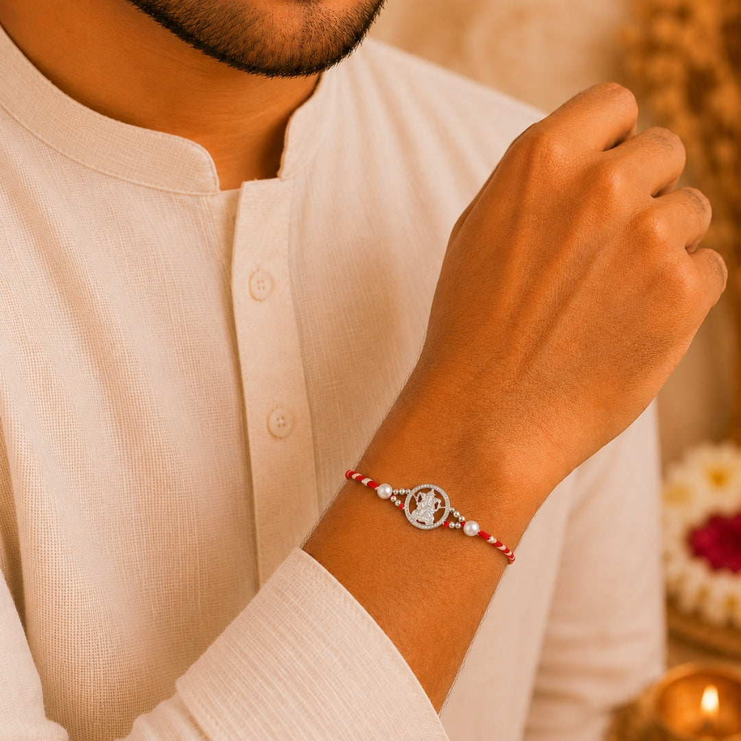 Brother wearing Silver Lord Ganpati Rakhi with Stone by Silviya – 925 silver rakhi for Raksha Bandhan.