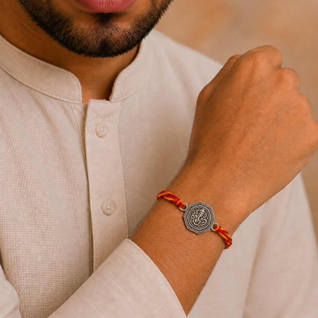 Brother wearing Silver Om Ganesha Rakhi by Silviya – spiritual 925 silver rakhi for Raksha Bandhan. 