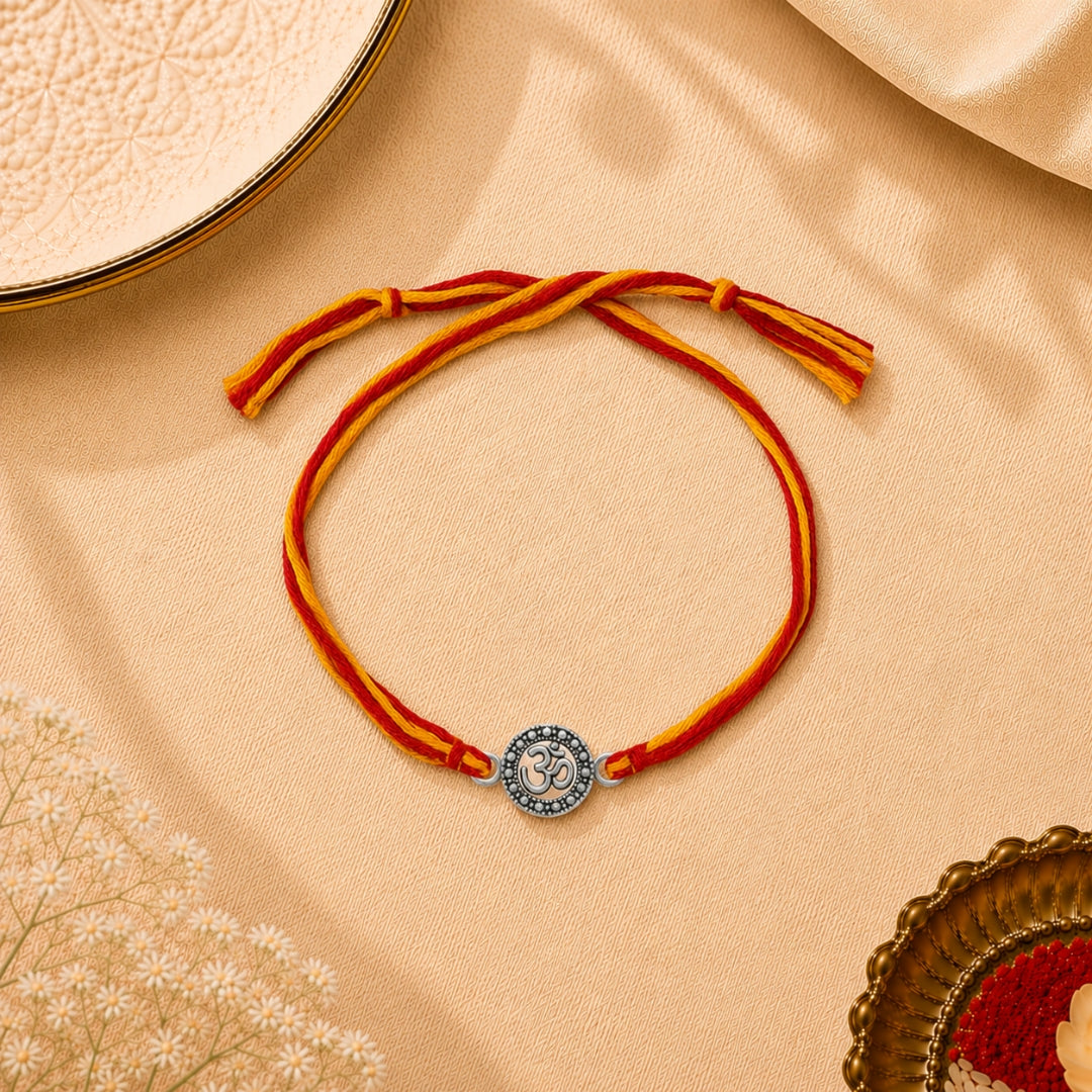 Silver Om Style Rakhi placed with roli chawal and festive decor – premium 925 silver Raksha Bandhan gift by Silviya.