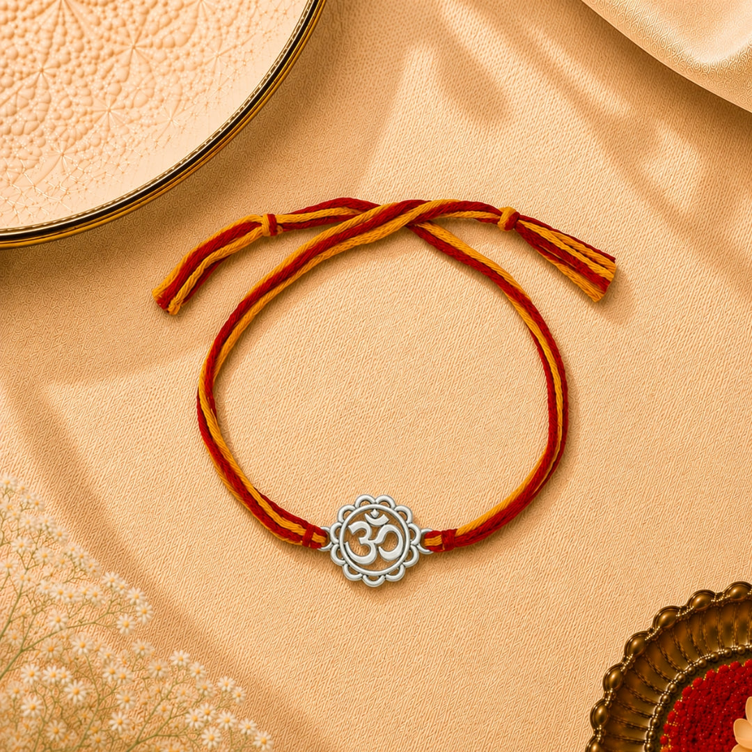 Silver Om Symbol Rakhi placed with roli chawal and festive decor – premium 925 silver Raksha Bandhan gift by Silviya.