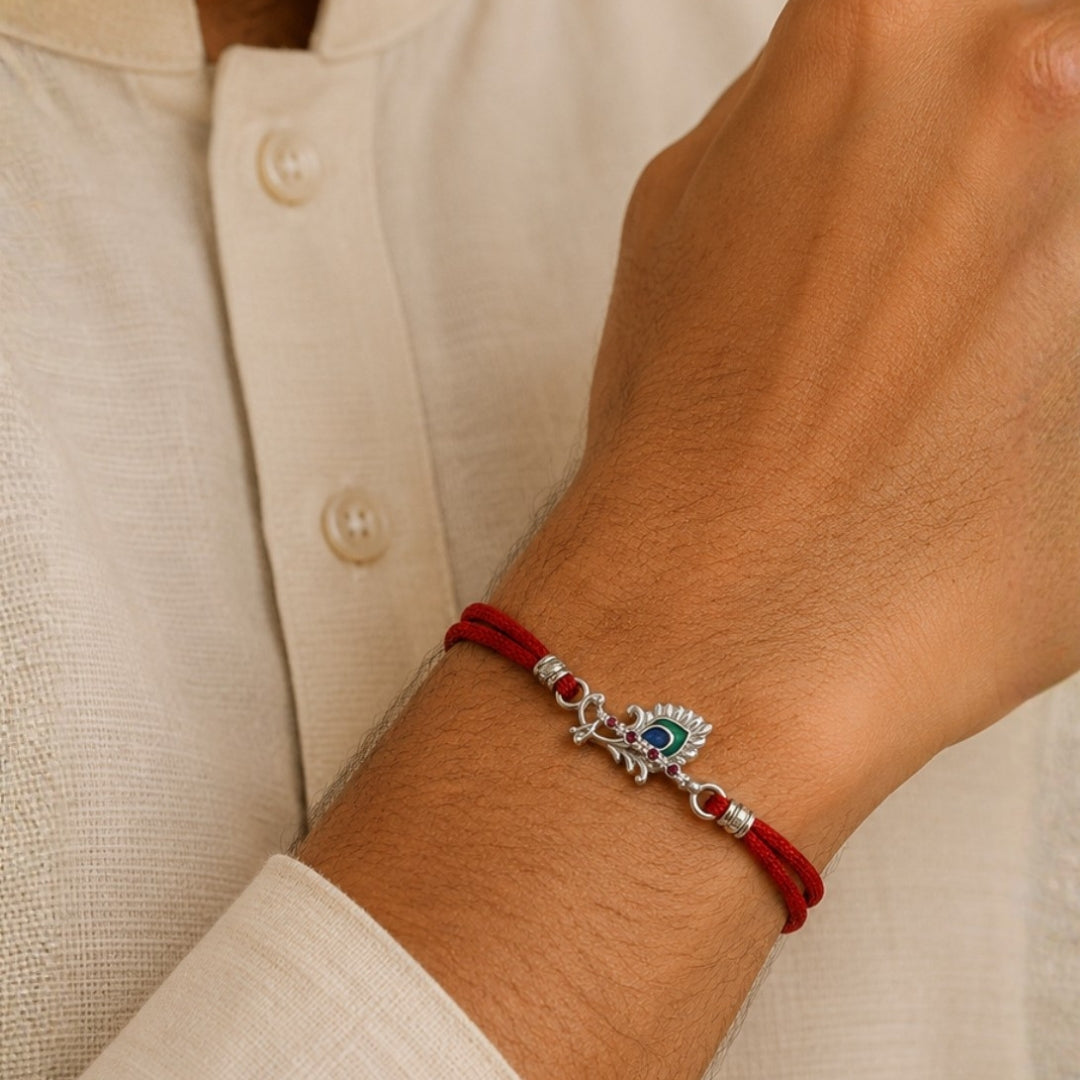 Brother Wearing Silver Pankh Bansuri Rakhi with Red Thread