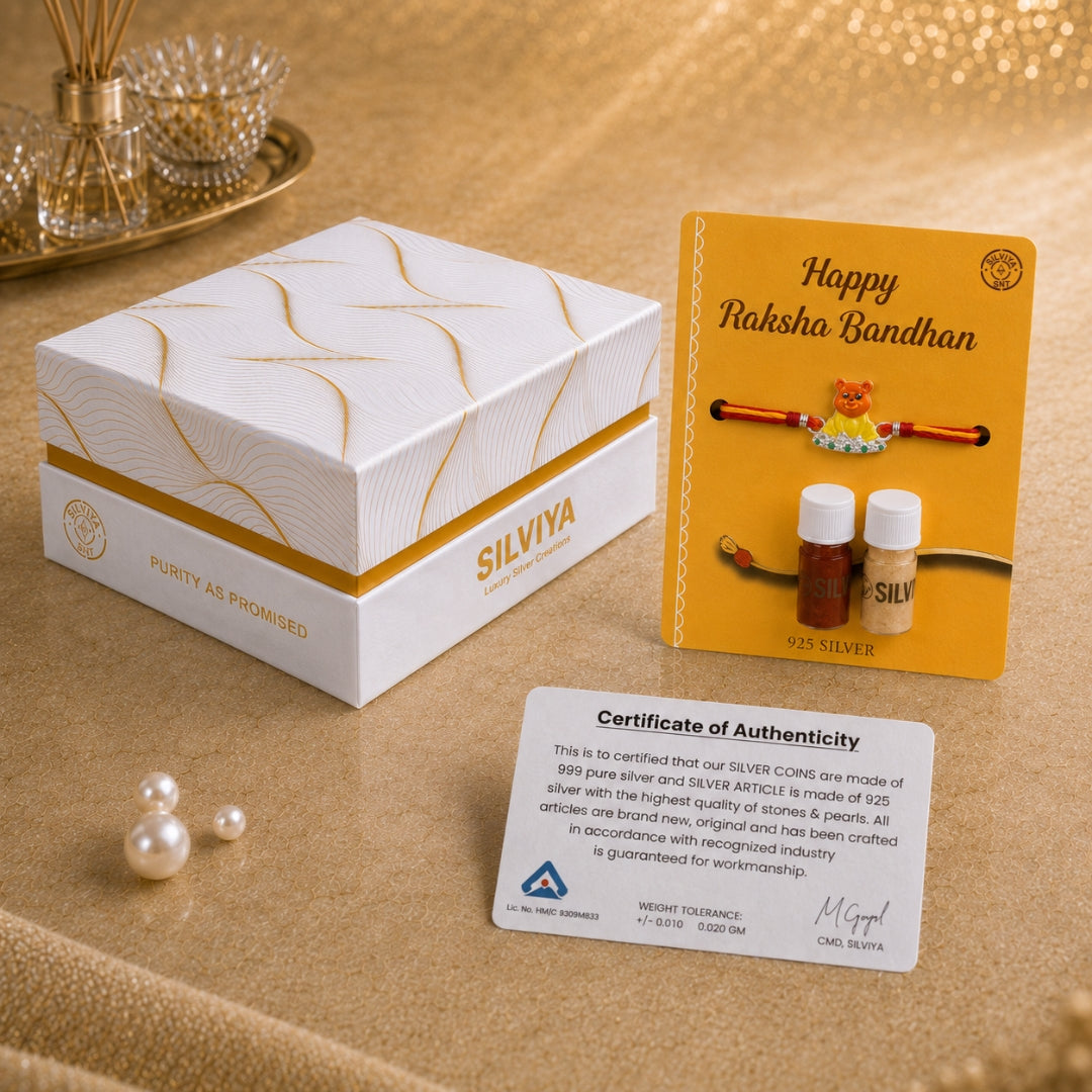 Premium Silviya gift box packaging for Silver Teddy Rakhi with green stones – ideal Raksha Bandhan rakhi for kids.