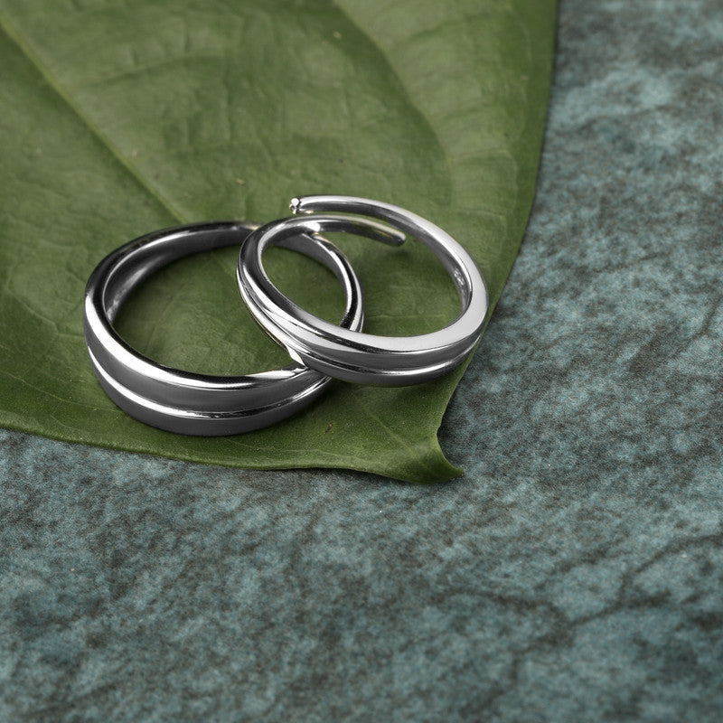 Trendy 925 silver couple rings displayed with props – romantic silver accessory set