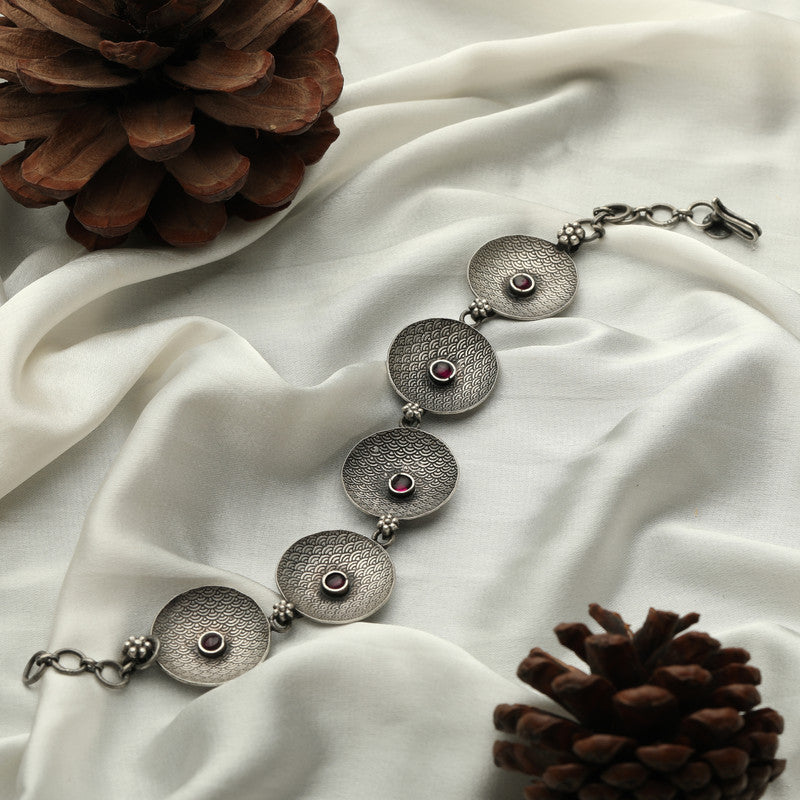 Victorian oxidized silver bracelet displayed on fabric background.