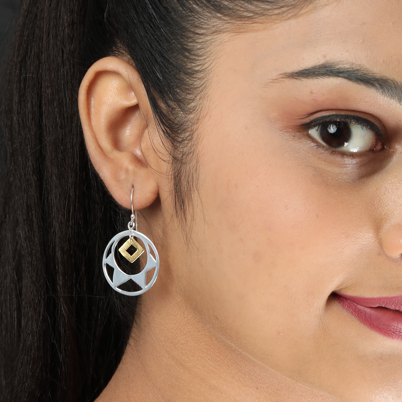 A woman wearing 925 sterling silver glittering gemstone earrings